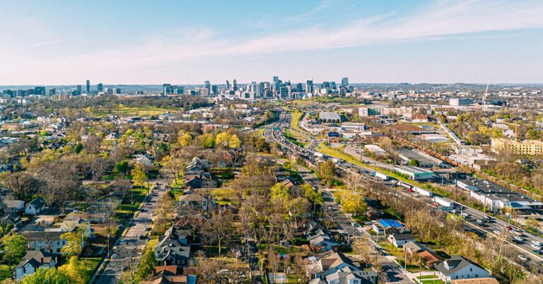 aerial photo residential neighborhood in foreground city skyline in background gettyimages 1488696044 1200w 628h