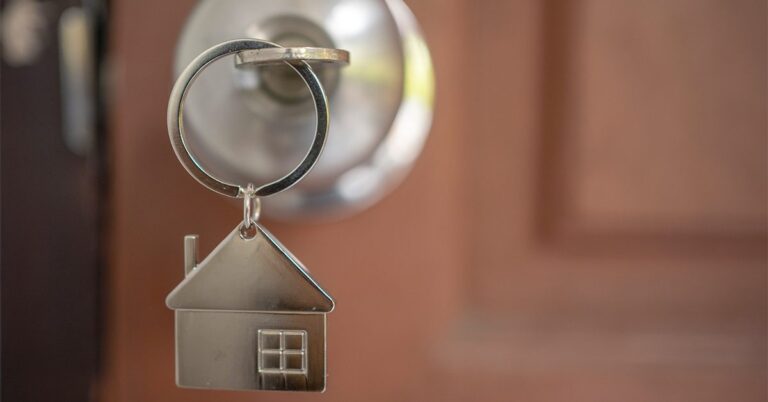 house shaped keychain with key in front door lock gettyimages 1222255613 1200w 628h