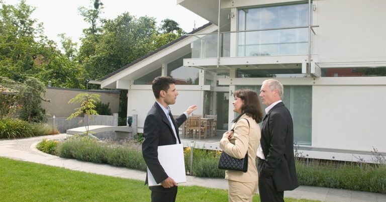 real estate agent outside home with clients gettyimages 200167300 001 1200w 628h