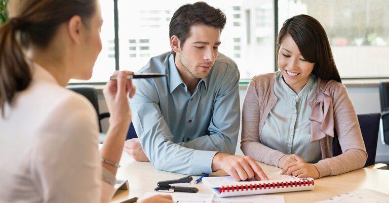 young couple and20businesswoman reviewing papers GettyImages 157859718 1200w 628h